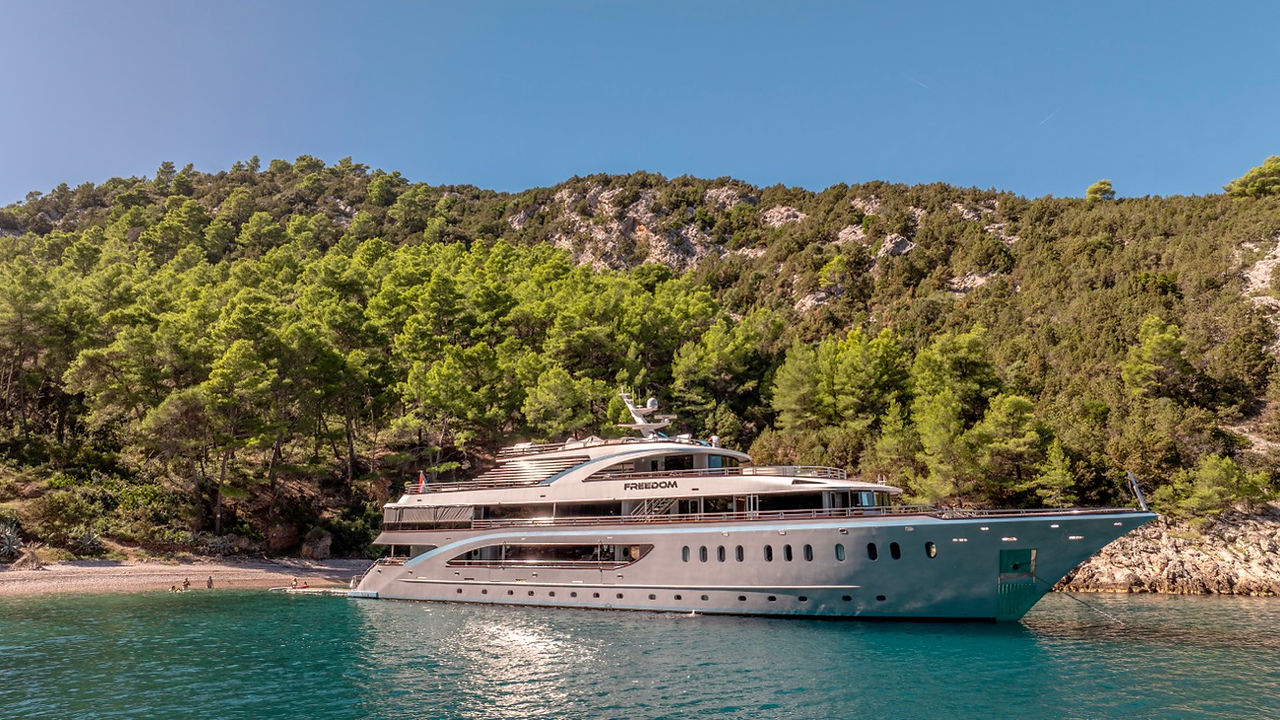 FREEDOM luxury motor yacht for big groups anchored in a bay in Croatia