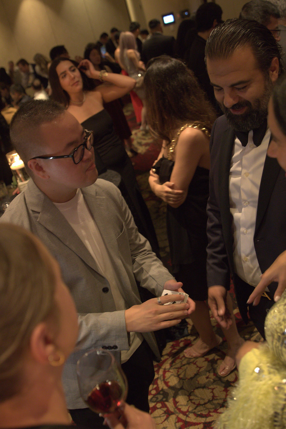 Tai performing magic at private event