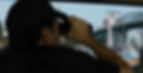 PI in back of van with binoculars