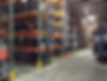 Warehouse shelves full of used car engines for sale at S&W Used Auto Parts.