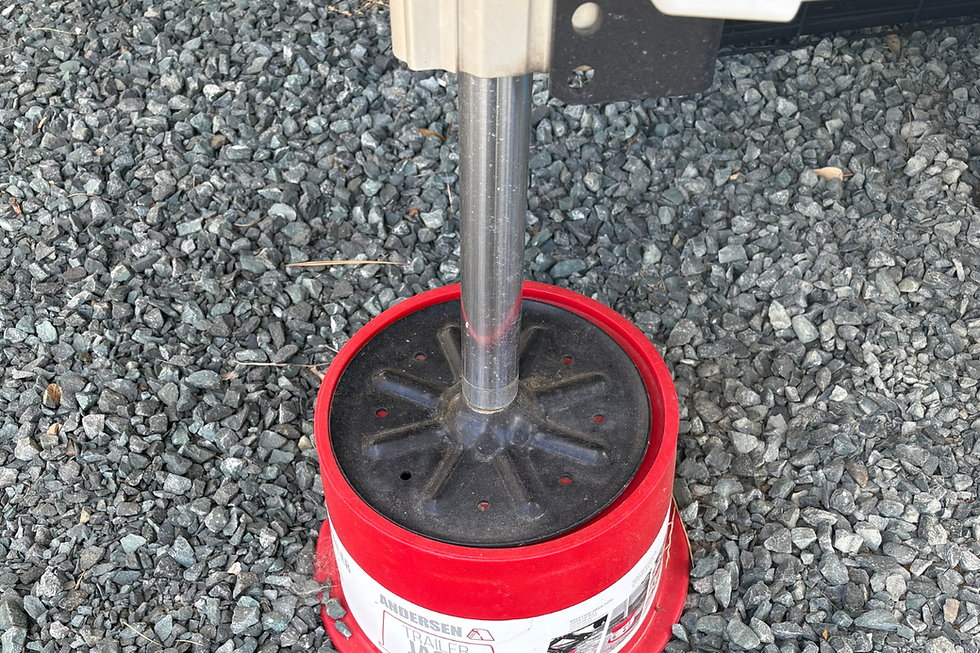 RV stabilizer jack resting on a red Anderson bucket.