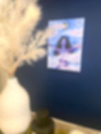 Original painting of the wind goddess. She is purple with black curly hair and is hovering in the pink transparent clouds.