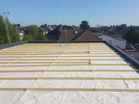 Insulation boards with a height gradient for flat roof renovation in London.