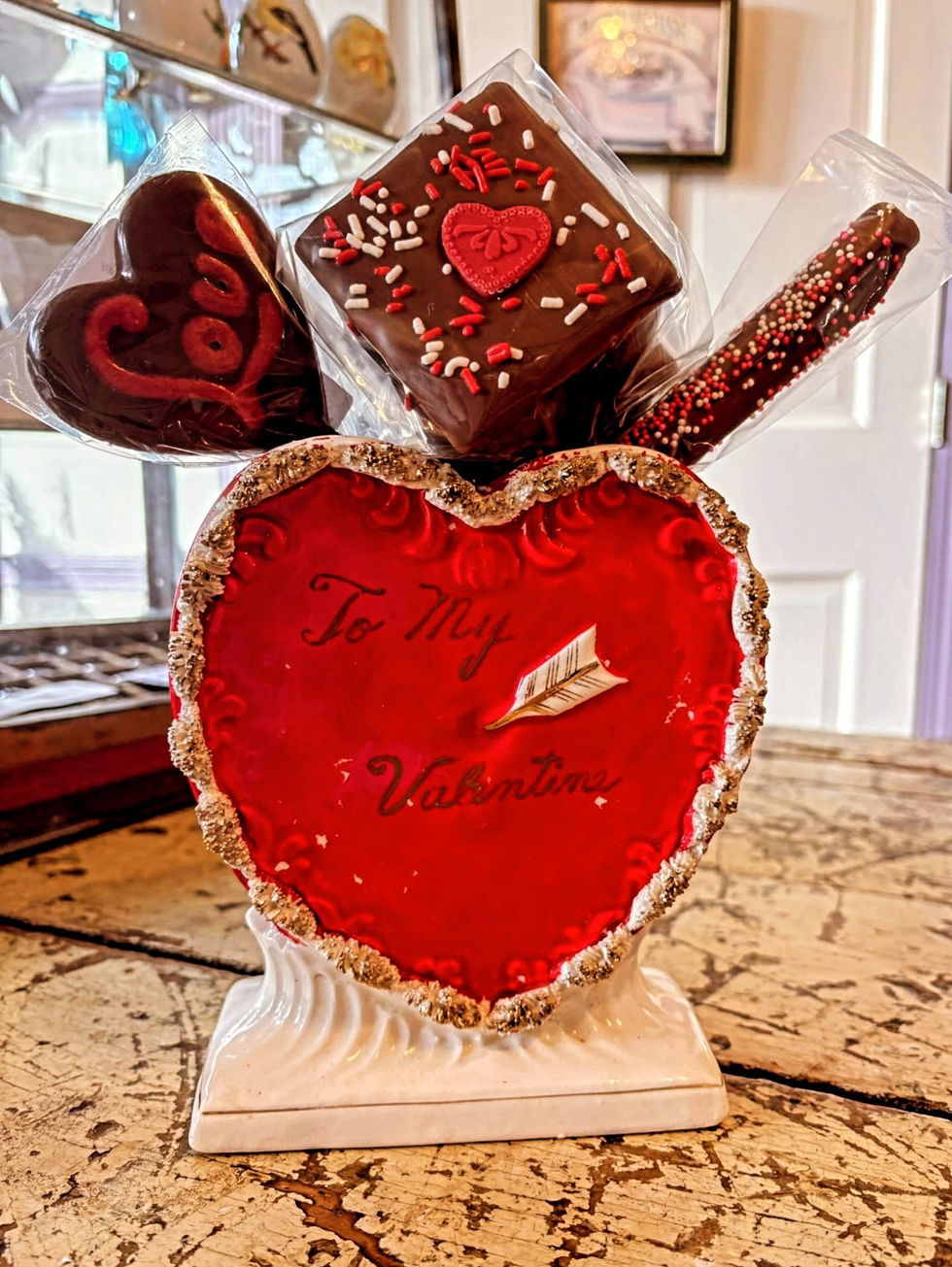 Heart-shaped Valentine’s Day chocolate arrangement on a table.