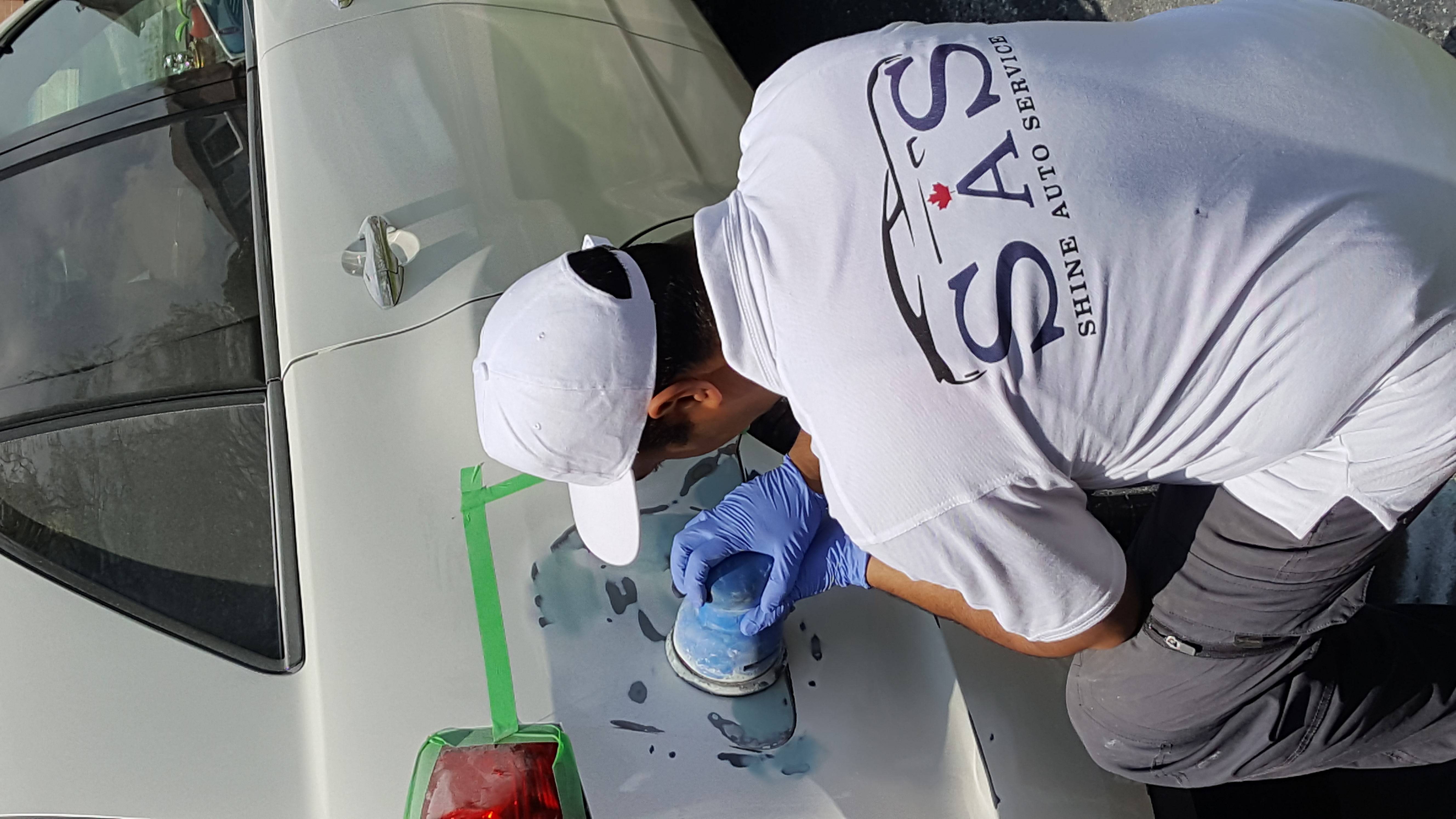 Shine Auto Service technician preparing a vehicle body panel for repair