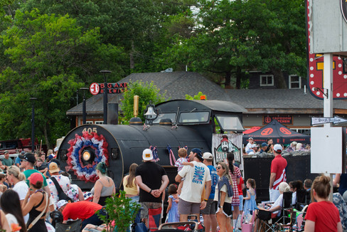 Scenes from the 2025 Nisswa Freedom Days Parade featuring floats, classic cars, local businesses, and community celebration.