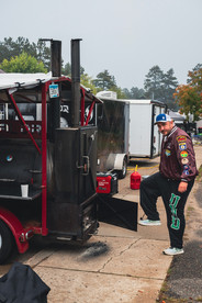 Crowds fill Downtown Nisswa under sunny skies during the 2025 Nisswa Fall Festival and Smokin’ Hot BBQ Challenge, with BBQ teams lined up, smoke rising from grills, and families enjoying the fall atmosphere.