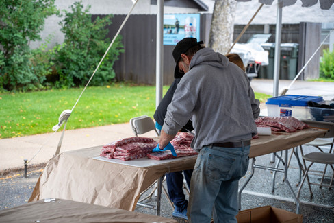Crowds fill Downtown Nisswa under sunny skies during the 2025 Nisswa Fall Festival and Smokin’ Hot BBQ Challenge, with BBQ teams lined up, smoke rising from grills, and families enjoying the fall atmosphere.