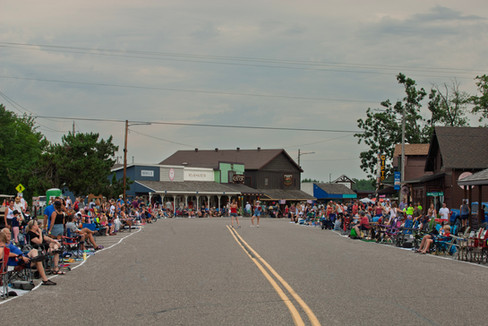 Scenes from the 2025 Nisswa Freedom Days Parade featuring floats, classic cars, local businesses, and community celebration.