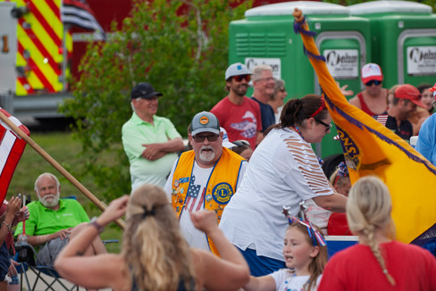 Scenes from the 2025 Nisswa Freedom Days Parade featuring floats, classic cars, local businesses, and community celebration.