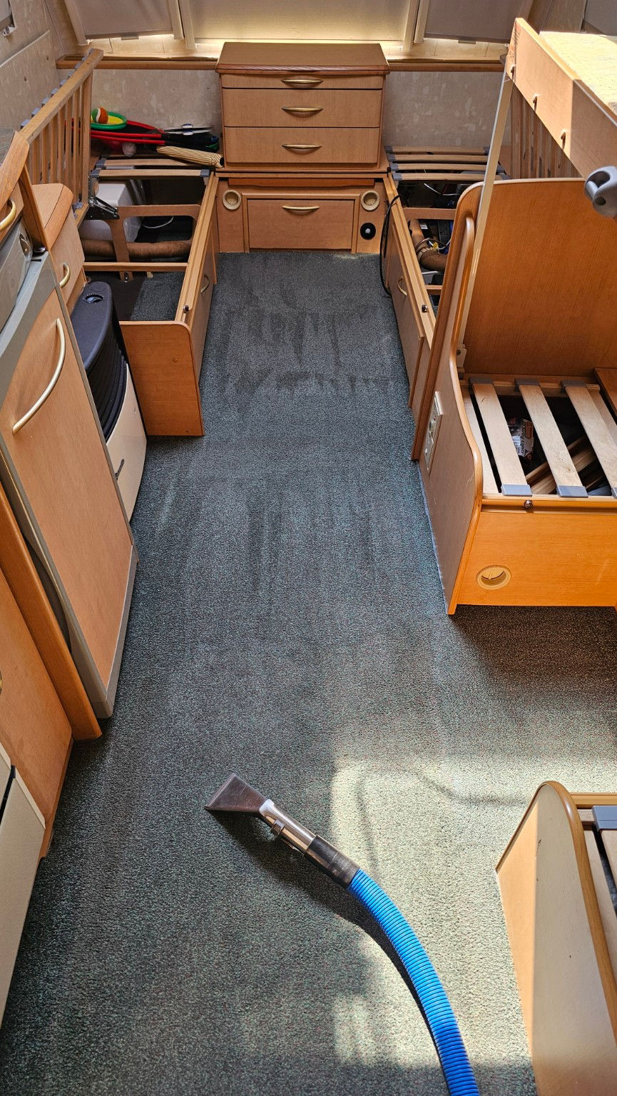 Grey carpeted floor inside a caravan