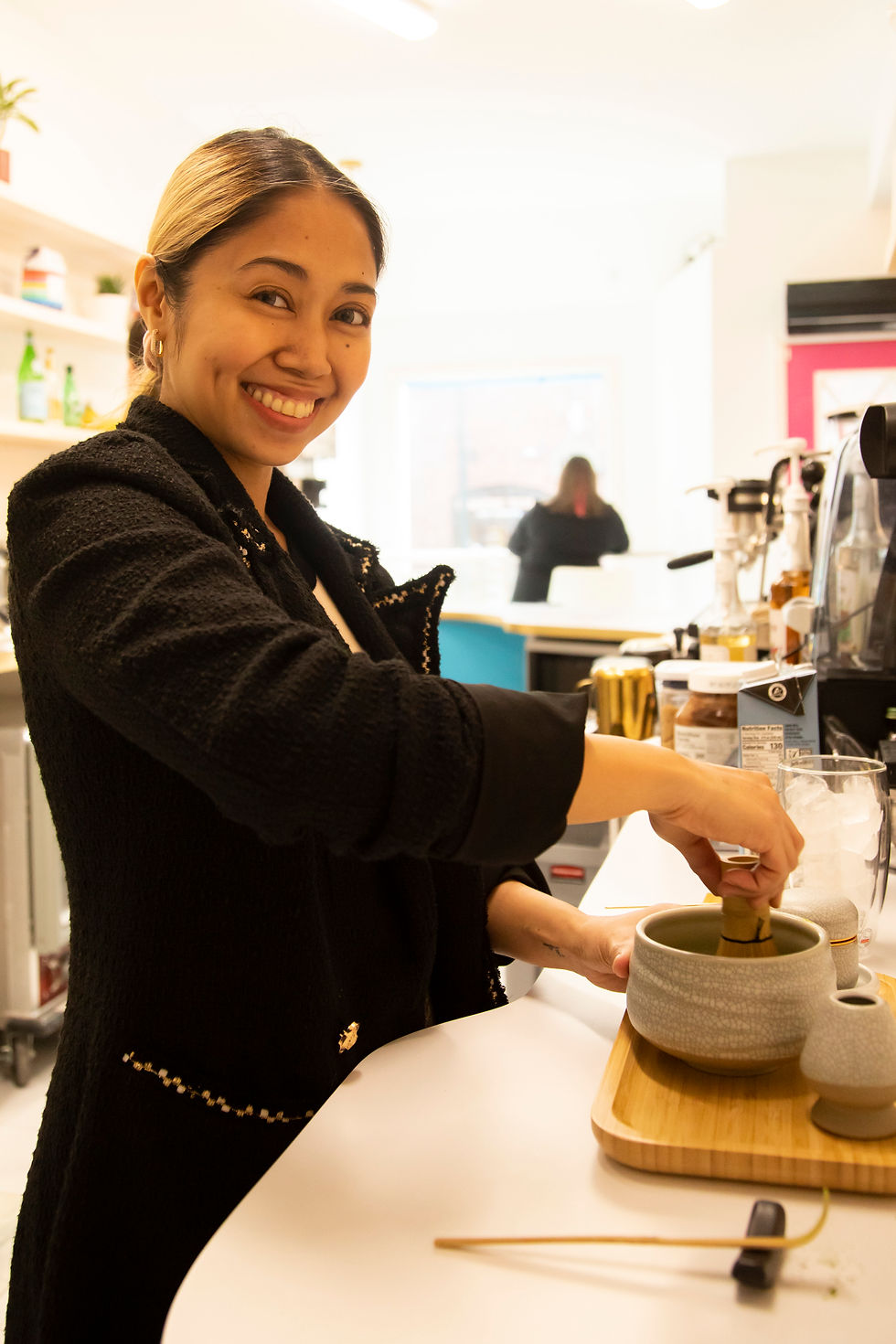 Woman making matcha tea.