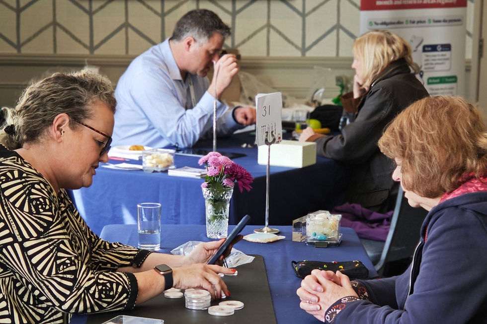 Expert Appraisers Kate and Edd at valuation tables with customers