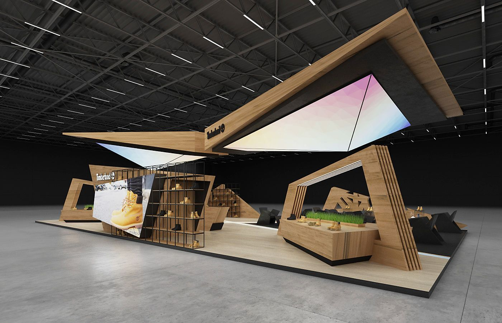 Modern trade show booth featuring angular wooden structures, a large screen with boots displayed, and geometric overhead lights.