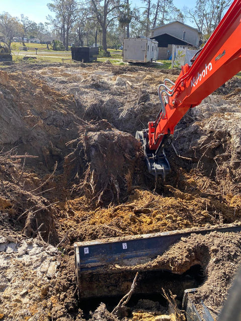 Stump removal service using excavator offered by County Line Land Clearing in Madison, Florida.