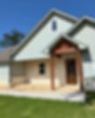 Modern light blue home painting project with wooden porch.