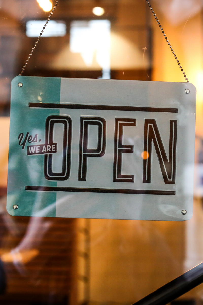 A sign in the window saying "Yes WE ARE OPEN" photo by Alexandre Godreau