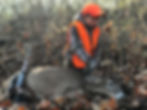 The author's son admiring his first harvested whitetail buck, as he grasps it's antlers for the first time.