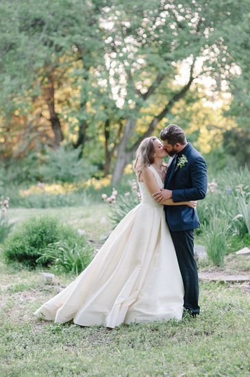 Bride and groom share a kiss on the Boxwood Villa grounds. 