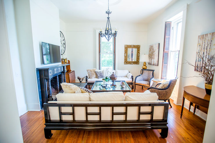 The inviting living room with a contemporary design offers enhanced comfort for guests, seamlessly blending with the historic architecture and fixtures of the home.