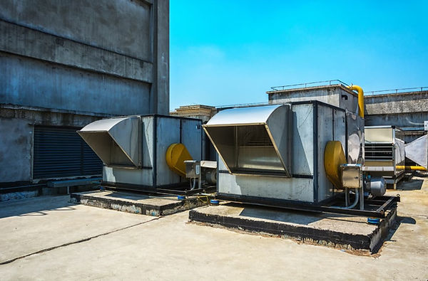 Technician inspecting control panel of HVAC unit in Orem facility.