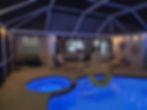 Rescreened pool cage with spa at night in Melbourne FL