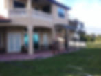Wide view of the two-story home and lanai enclosure during construction — Jeremy's Screen Repair & Handyman Service
