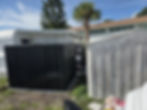 Black metal shed and fence panels installed beside a mobile home — Jeremy's Screen Repair & Handyman Service