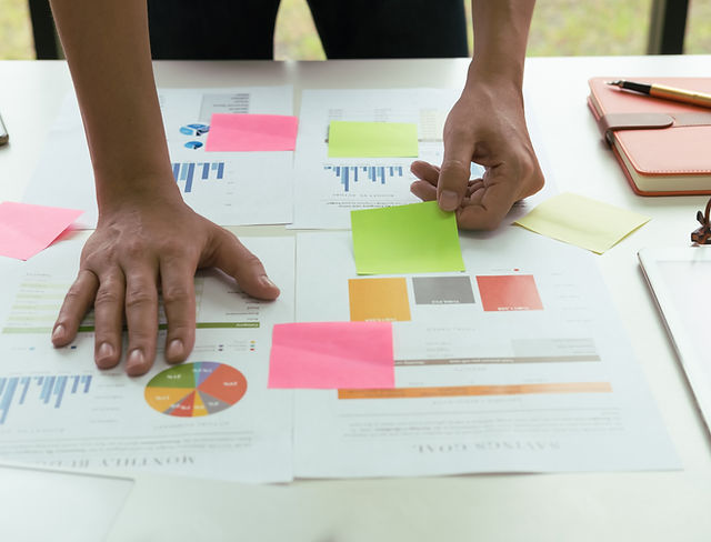 hands leaning over data sticky notes.jpg