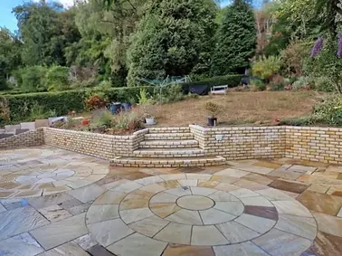 sandstone patio with sandstone retaining wall in surrey.webp