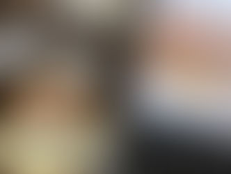 A cup of coffee next to a laptop open on NK marketing's website