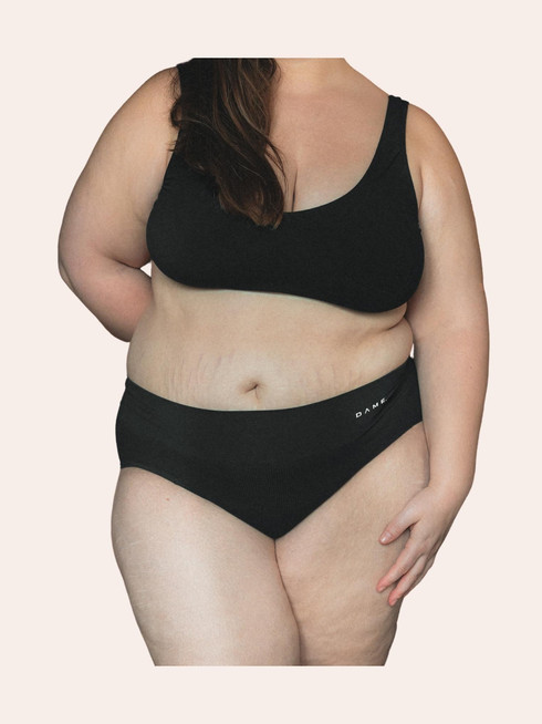 Kayleigh is wearing the black DAME period pants, NIght in size Large