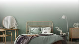 Serene bedroom with green ombre wall, bamboo bed