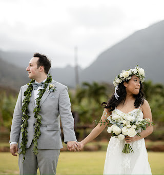 Wedding couple holding hands outdoors with mountains