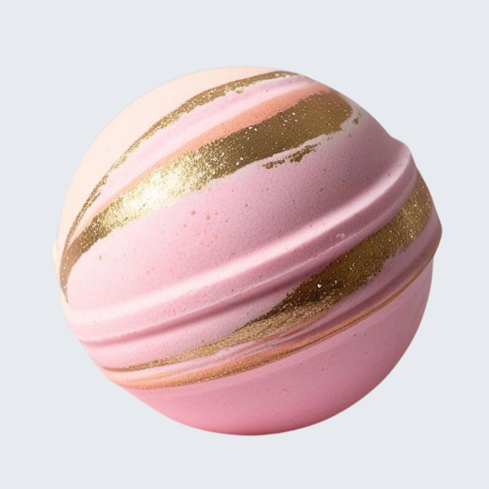 A pastel-colored bath bomb with swirls of pink, peach, and gold, designed to create a glowing bath experience.