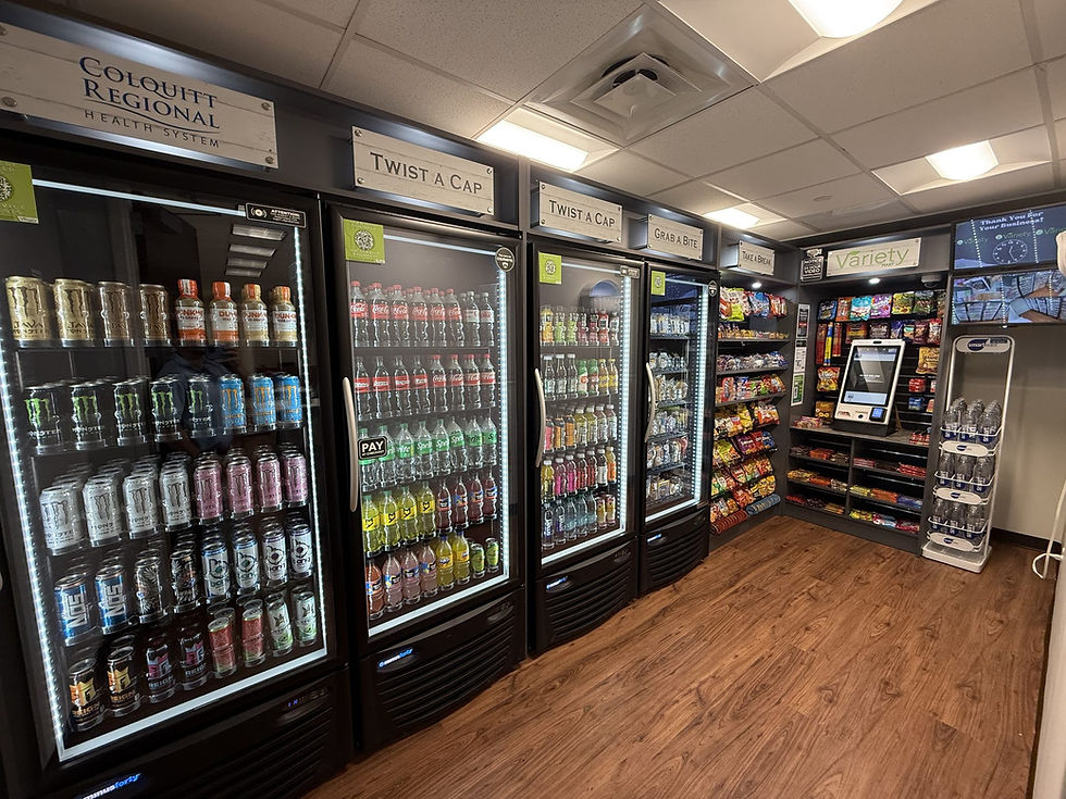 Corner micro market at Colquitt Regional Medical Center with lit beverage coolers, snack shelving and a self-checkout kiosk
