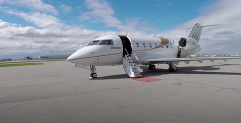 Challenger 650 jet on runway with open stairs.