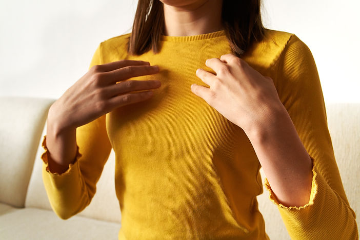 Teenage girl practicing EFT or emotional freedom technique - tapping on collarbone point,