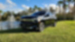 Orlando Luxury Transportation Service SUV parked on grass