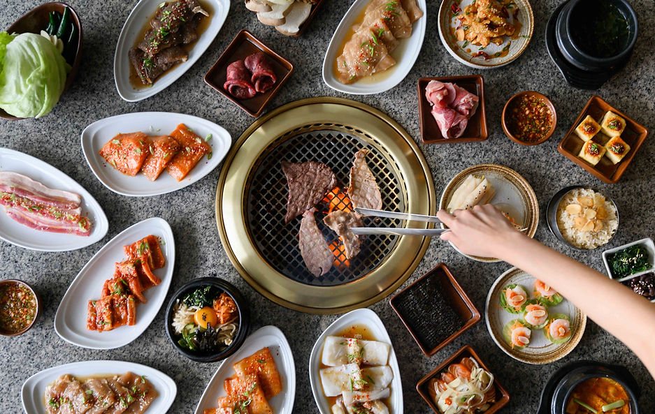 Korean BBQ restaurant table with grilled meats.