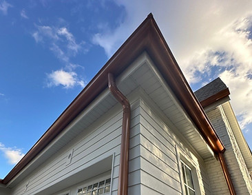 Copper gutter and downspout installation on a residential home