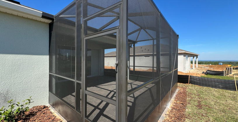 Modern screened-in patio enclosure on a residential home.