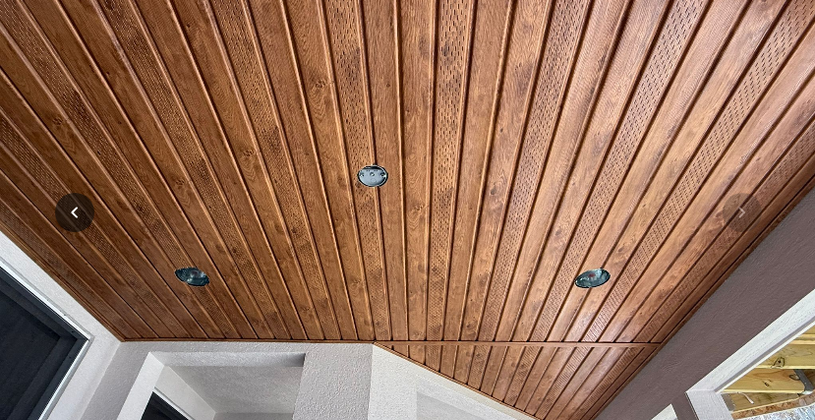 Outdoor porch with wood plank ceiling and recessed lights