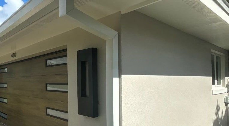 Modern garage exterior with white gutters and trim