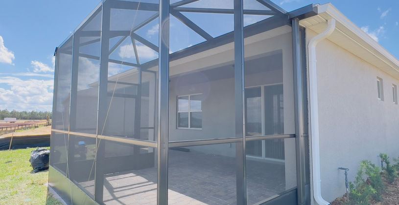 Screened-in patio enclosure on the back of a house.