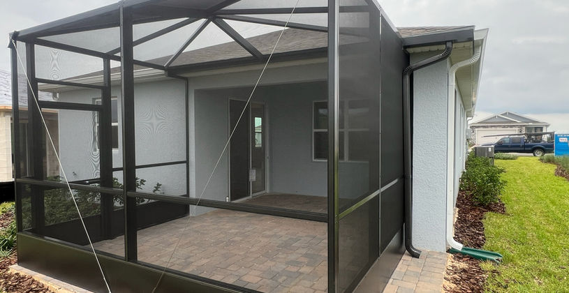 Modern screened-in patio enclosure on a residential home.
