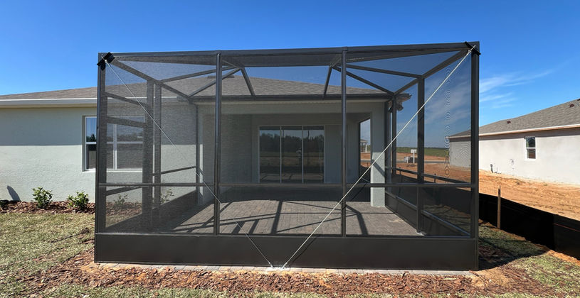 Modern screened-in patio enclosure on a residential home.