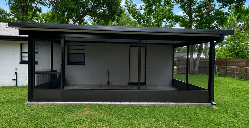 Modern black screened-in patio enclosure in a grassy backyard