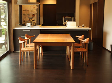 Wide dining table with round legs, cherry
