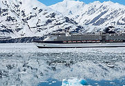 alaskan cruise through snowy mountains reflecting in water